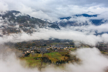 Mountain village covered in fog. Foggy mystic valley. Esterri d'Àneu, Pyrenees, Spain. Spanish travel destination. 