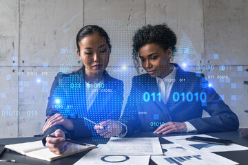 Two businesswomen work together in modern office on new project. Double exposure. Concept of success. Planet earth world map.