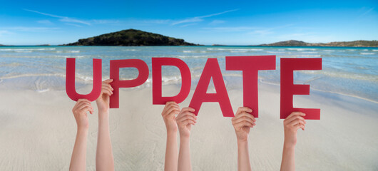 People Hands Holding Colorful English Word Update. Ocean And Beach As Background