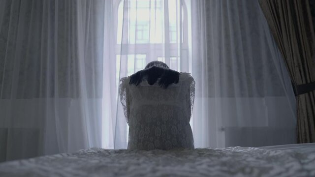 Unhappy bride crying on the bed, crisis in relationship, cancellation of wedding