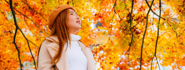 young woman in autumn park travel in Japan,Banner cover 