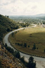 Altai nature at dawn in the fog. Haze in the forest and on the lake, atmospheric weather for the screensaver.