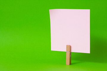 paper notes and clothespins isolated on orange background
