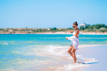 Young woman in white on the beach