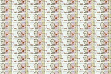 100 Ukrainian hryvnias bills printed in money production conveyor. Collage of many bills. Concept...