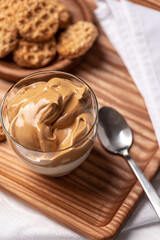 Delicious cookies and coffee mousse on a wooden tray.