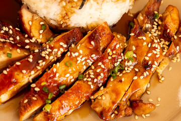 Toriyaki chicken rice on a plate, served with food photos, top view