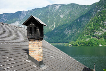 Old style chimney on the Roof in the Old house near the lake.