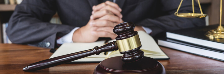 Counselor in suit or lawyer working on a documents in courtroom