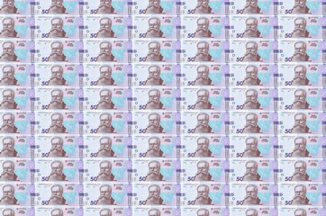 50 Ukrainian hryvnias bills printed in money production conveyor. Collage of many bills. Concept of...