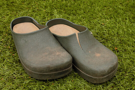 Pair Of Old Comfy Gardening Clogs With A Split In One Of The Clogs