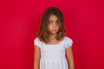 Portrait of displeased upset Little caucasian girl with blue eyes  frowns face as going to cry, being discontent and unhappy as can't achieve goals,  Disappointed young man has troubles