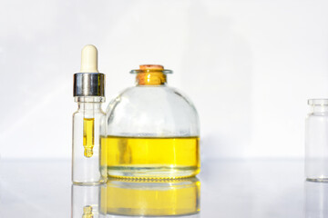 Glass bottle with CBD oil, THC tincture and hemp leaves on a white background lab. Cosmetics CBD oil. Banner Copy space, close-up