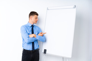 Young businessman giving a presentation on white board giving a presentation on white board and pointing it