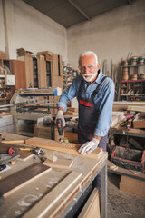 Carpenter using an electric drill