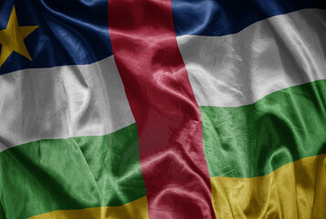 colorful shining big national flag of central african republic on a silky texture