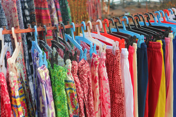 Colorful Indian and Nepalese clothes on hangers at the bazaar.