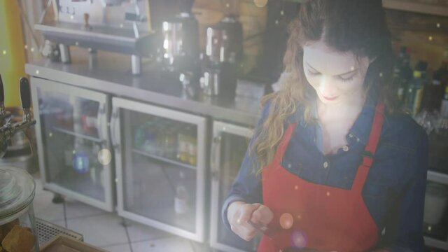 Animation of light circles and white dots floating over Caucasian female waitress