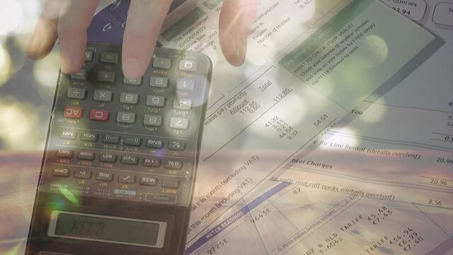 Animation of white light circles floating over Caucasian woman using a calculator