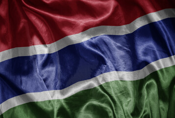 colorful shining big national flag of gambia on a silky texture