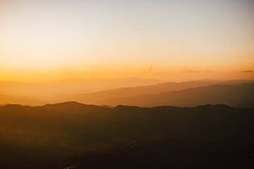 View of silhouatte of mountain range under the sky during the sunset. Beautiful evening nature background.