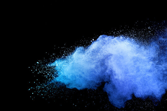 Closeup of blue dust particle splash isolated on black background.
