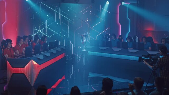 Two Esport Teams of Pro Video Game Players Playing in a Championship Arena. Cyber Games Online Tournament Event with Competing Gamers, Spectators Cheering. Live Streaming. Crane Panoramic Shot 