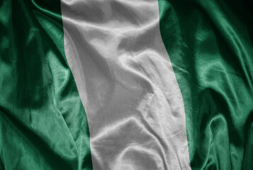 colorful shining big national flag of nigeria on a silky texture