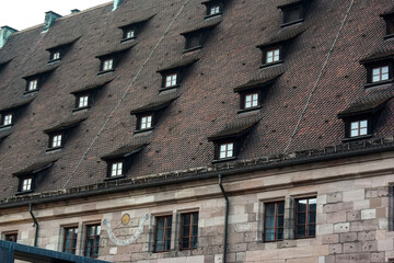 Fototapeta na wymiar Traditional Bavarian tiled roof with windows. Germany.