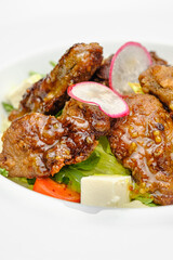 Grilled beef in a sauce with Dejon mustard and soft cheese in a case plate on a gray background.