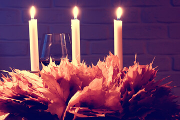 candles yellow leaves background autumn / abstract festive warm still life with candles