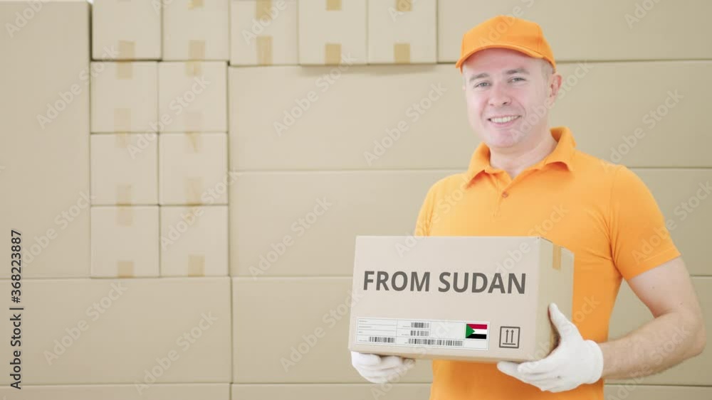Aufkleber warehouse worker holds cardboard box with printed from sudan text on it