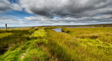 Fototapeta premium The Cupola chimney and adjacent reservoir. Grassington moor lead mines. Yorkshire Dales National Park