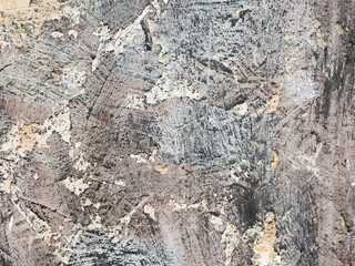 Abstract creative background of chaotic strokes of old cracked paint on concrete wall. Old surface with traces of paint, weathered, scratches and cracks for design