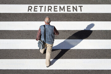 Retirement concept. Scene of a senior man walking in a crosswalk towards retirement text. Top view
