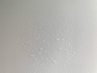 Water droplets formed by condensation on a white surface. The white wall after the rain condensing...
