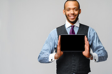 young handsome african-american businessman holding tablet pc
