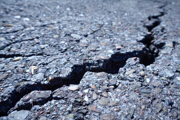 Crack in the asphalt road. Background image.