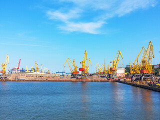 Fototapeta premium Odessa, Ukraine - July 6, 2016: Container cranes in cargo port terminal, cargo cranes without job in an empty harbor port. A crisis. Defaulted paralyzed entire economy of state, in the EU candidate