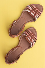 Women's sandals on a yellow background. Summer shoes