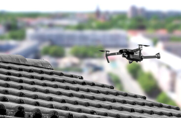 Drone in the air inspecting the roof over the house. Close-up © EKH-Pictures