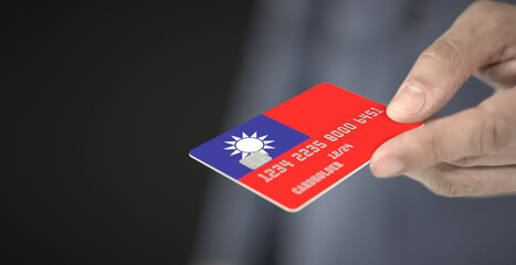 Unknown man gives plastic bank card with printed flag of Taiwan. Fictional numbers