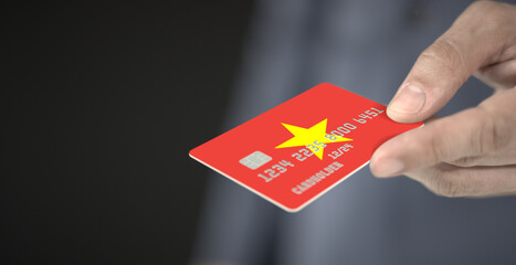 Unknown man gives plastic bank card with printed flag of Vietnam. Fictional numbers