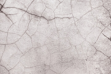 Abstract creative background of chaotic strokes of old cracked paint on concrete wall. Old surface with traces of paint, weathered, scratches and cracks for design