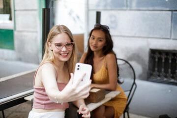 Two girl are sitting in a bar