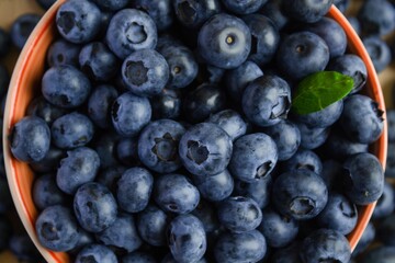 Fresh blueberry in wooden bowl. Top view Texture blueberries background close up with copy space for text.  Concept of healthy and dieting eating.  Summer healthy food. Banner.