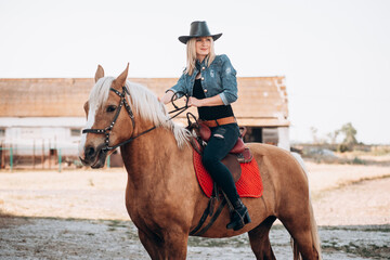 Beautiful girl riding a horse in countryside.
