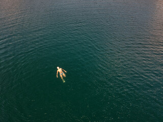 15 year old teenager boy swims in the deep sea