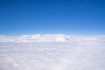 Aerial view of cloudscape seen through airplane window