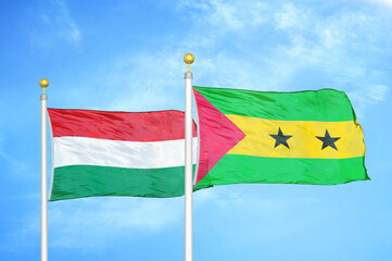 Hungary and Sao Tome and Principe two flags on flagpoles and blue cloudy sky